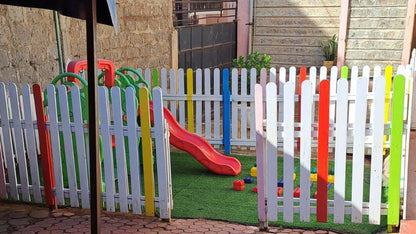 Colorful wooden picket fence for kids play area division at school or daycare