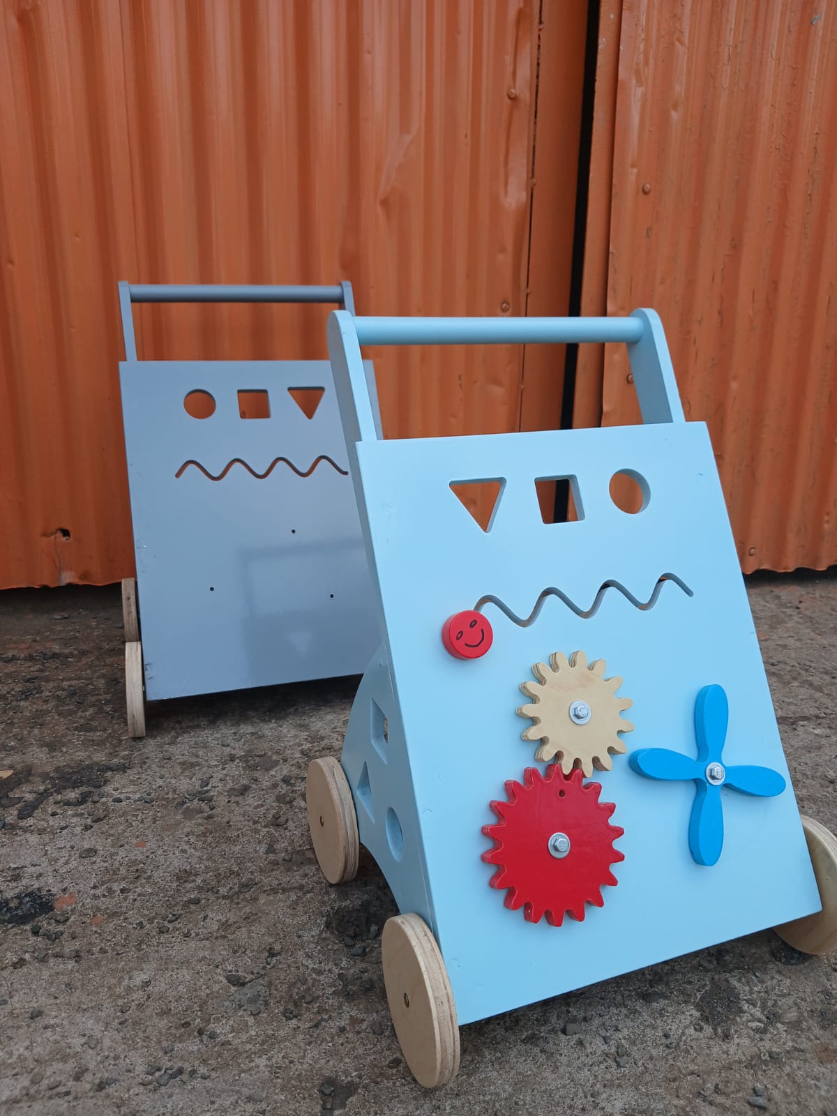 Colorful wooden toddler push walker with gears, spinner and shape sorter activity board