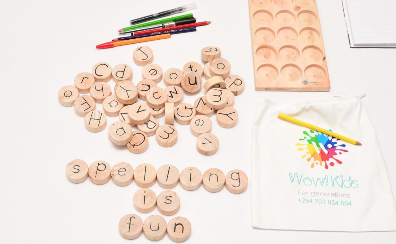 Early reading wooden toy for kids 3+ with letter coins and word formation board in English, Spanish, Swahili, and French