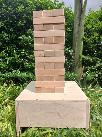 Giant Jenga blocks arranged in a tall tower for outdoor play