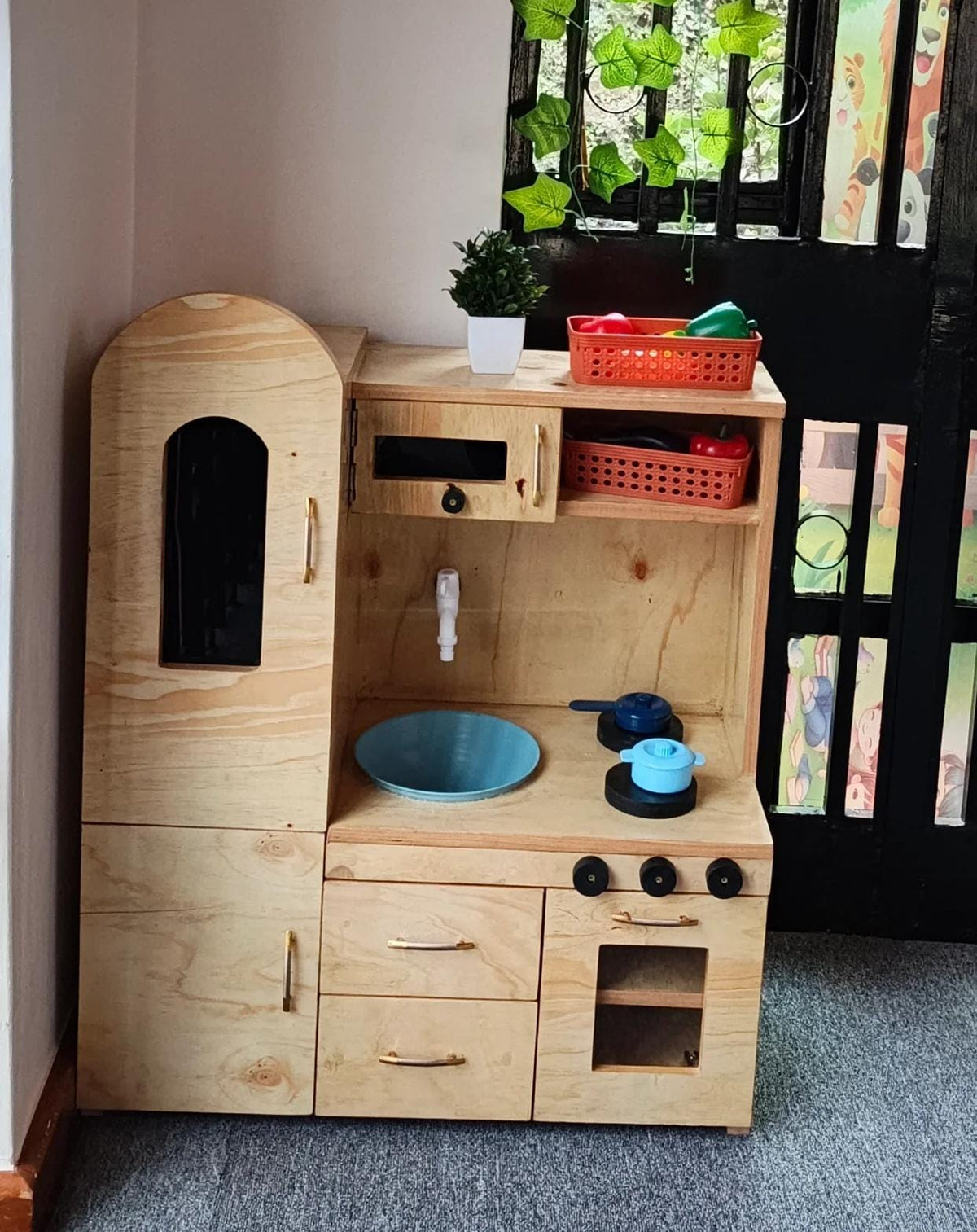 Kids playing with a wooden mud kitchen