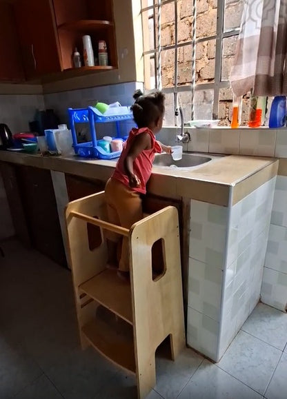 Montessori kitchen helper tower for toddlers helping with kitchen chores