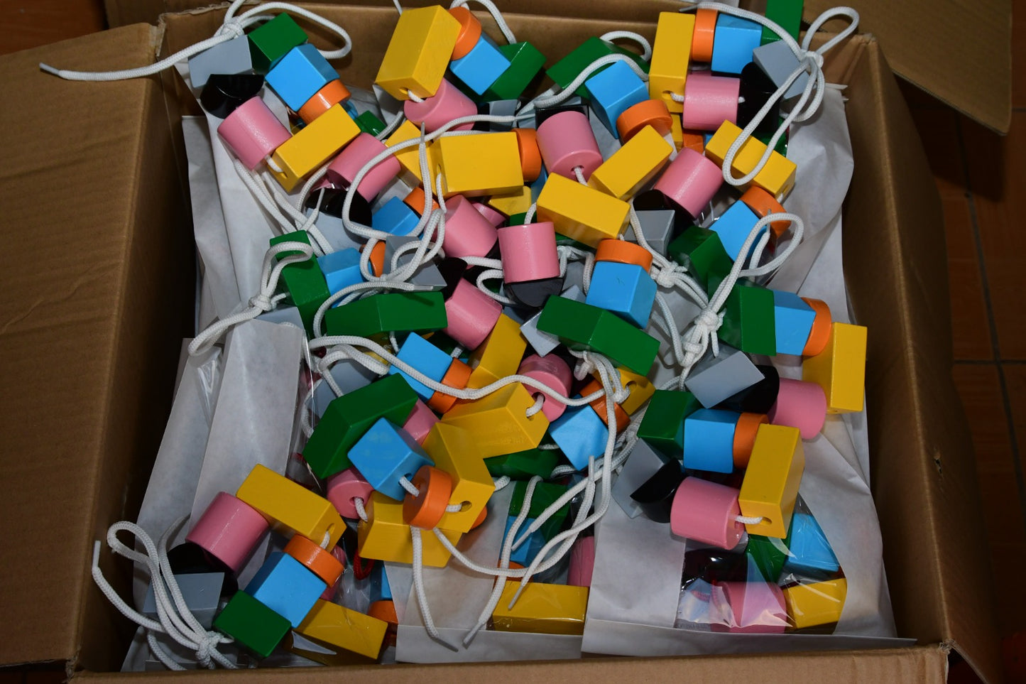 Multicolored wooden lacing blocks for early learning play