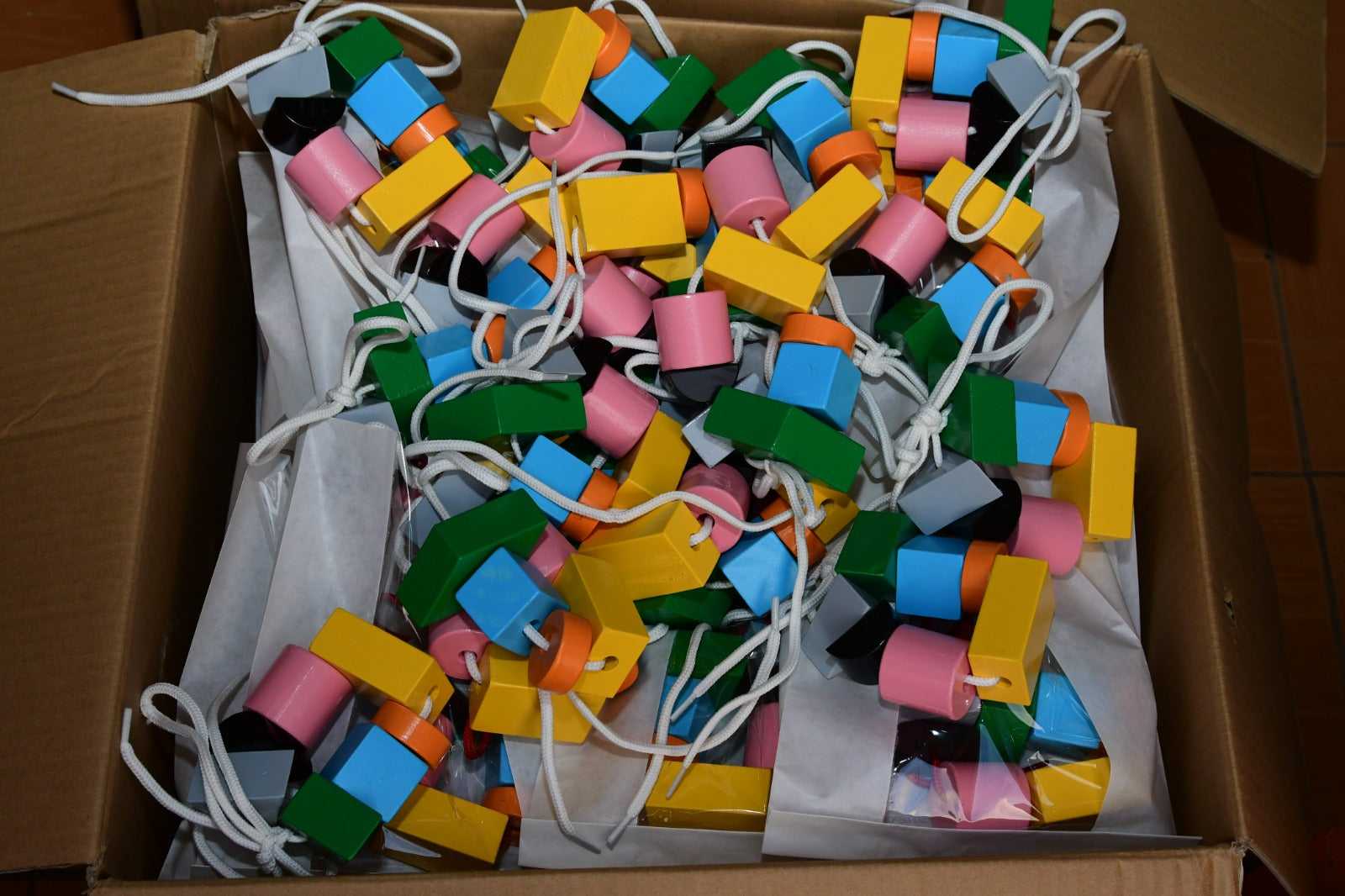 Multicolored wooden lacing blocks for early learning play