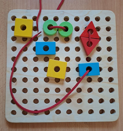 Wooden lacing board with threading shapes and colorful laces for fine motor skills development Kenya