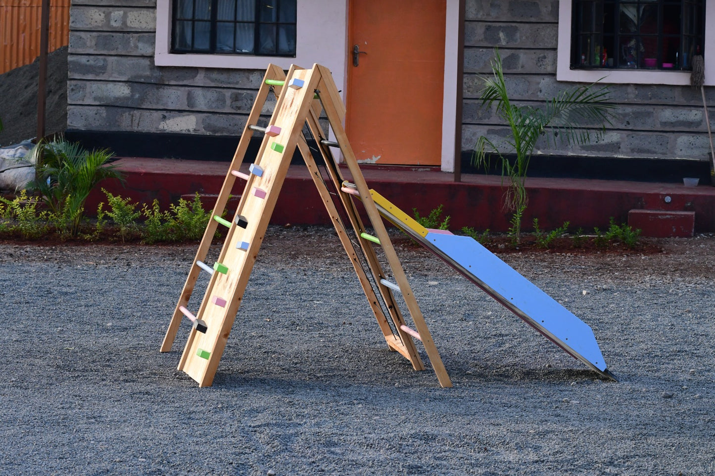 JWooden climbing wall feature on jungle gym for toddlers and older kids