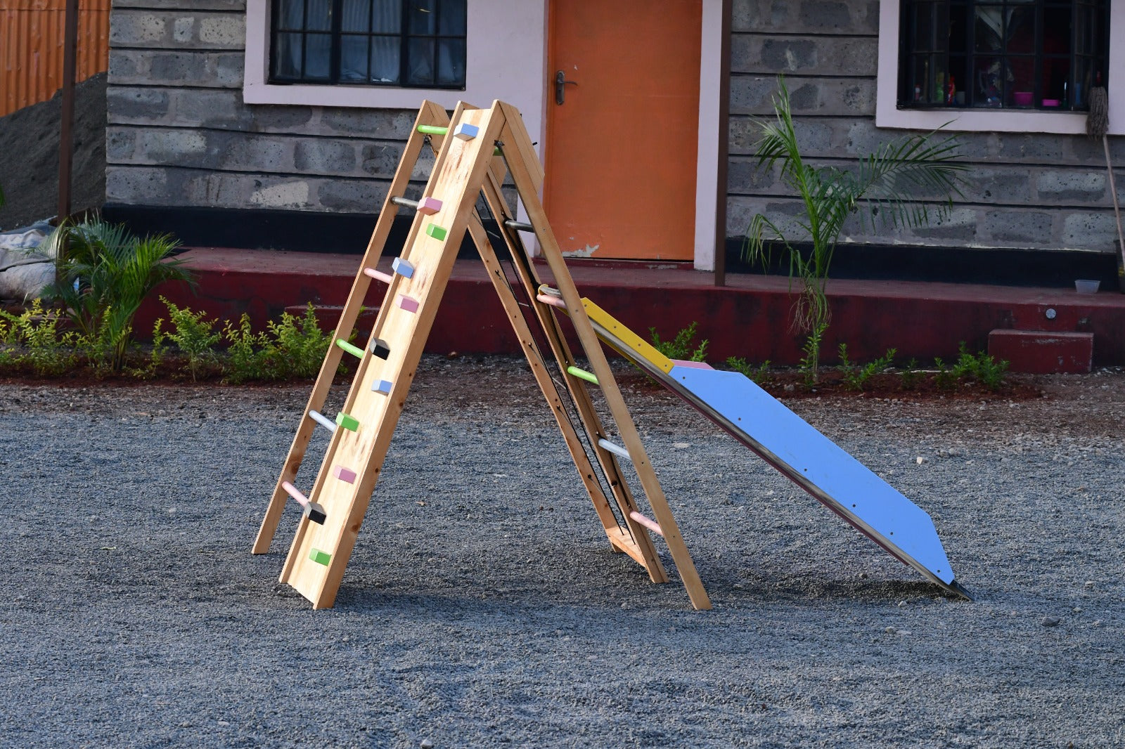 JWooden climbing wall feature on jungle gym for toddlers and older kids